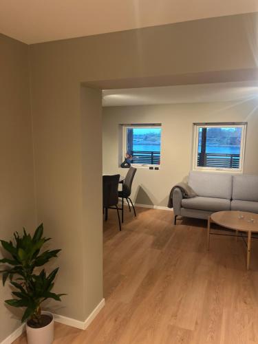 a living room with a couch and a table at Apartment right by Karmsund in Karmøy