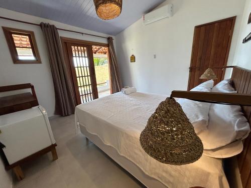 a bedroom with a bed with a basket on it at Pousada Vila de Água Boa in Salvaterra
