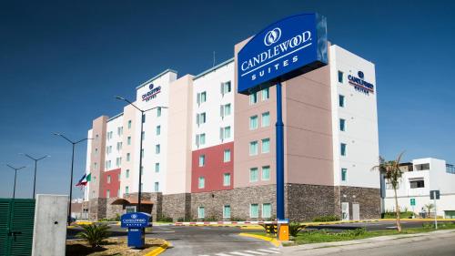 a large building with a sign in front of it at Candlewood Suites - Queretaro Juriquilla by IHG in Querétaro
