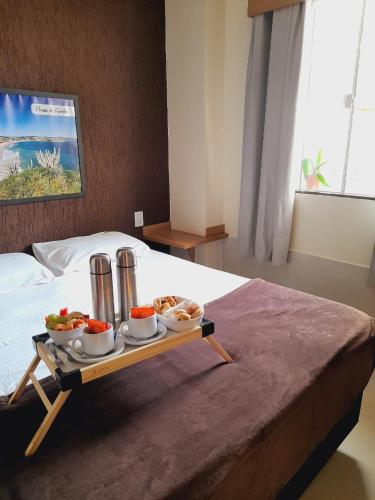 a tray of food on top of a bed at Suites Vento Solar Buzios in Búzios