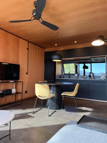 a kitchen with two chairs and a table and a ceiling fan at Casa Mara Sierra 2 in Nueva Carrara