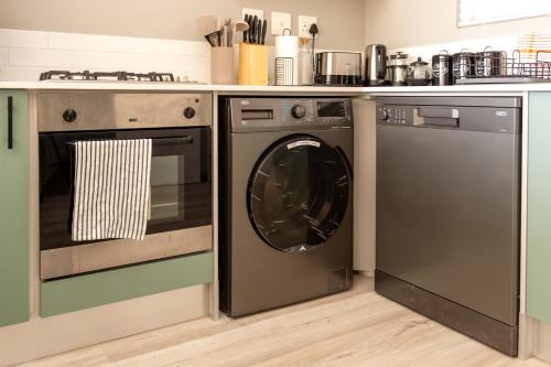 a kitchen with a washing machine and a dishwasher at Port Owen Marina by First Private Stays in Velddrif