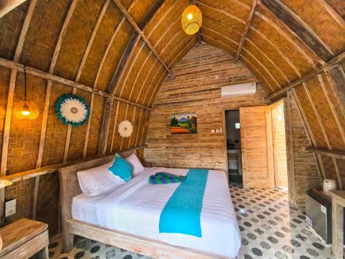 a bedroom with a bed in a wooden room at Brady's Ubud Villas in Ubud