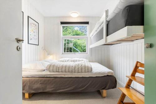 a small bedroom with a bed and a window at LF16121-Farso-Bjarkesvej-11 in Farsø