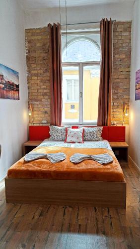 a bedroom with a large bed with a large window at GoodMo Budapest Smart Rooms in Budapest