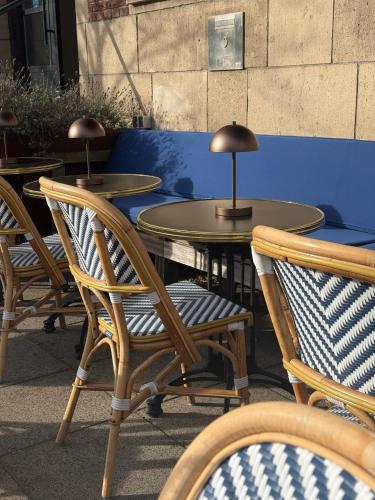 um conjunto de mesas e cadeiras com luminárias sobre elas em Hotel Bleecker by BHC em Bloemendaal