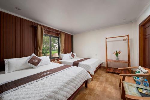 Ένα ή περισσότερα κρεβάτια σε δωμάτιο στο Tamcoc Moon An Bungalow & Restaurant