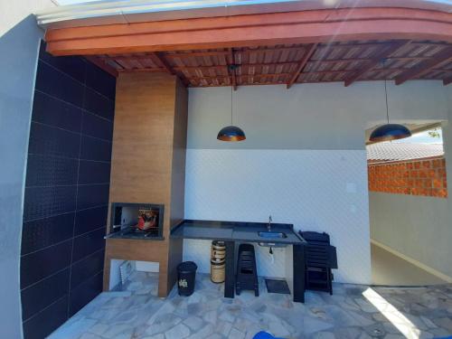 a model of a patio with a table and a stove at Linda Casa de Praia com Piscina em Itapoá in Itapoa