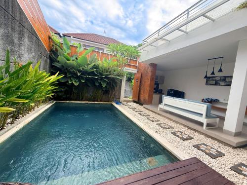 a swimming pool in the middle of a house at Villa Leyan 1 Semer - Between Seminyak & Canggu in Seminyak