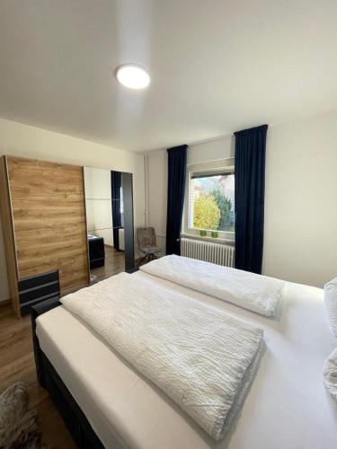 a bedroom with two beds and a window at HarzRoots mit Garage in Bad Harzburg