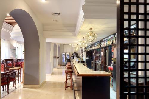 a bar in a restaurant with tables and chairs at Crisol Monasterio de San Miguel in El Puerto de Santa María