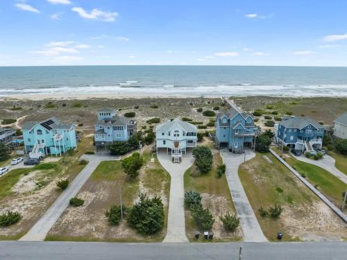 an aerial view of houses and the ocean at Elegant Updated Oceanfront Home with Pool & Hot Tub in Waves