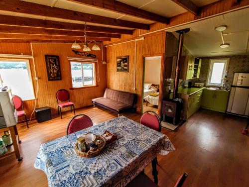 a kitchen and living room with a table and chairs at Casadelaisla-Rilan in Rilán