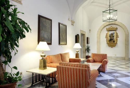 a living room with two couches and a table at Crisol Monasterio de San Miguel in El Puerto de Santa María