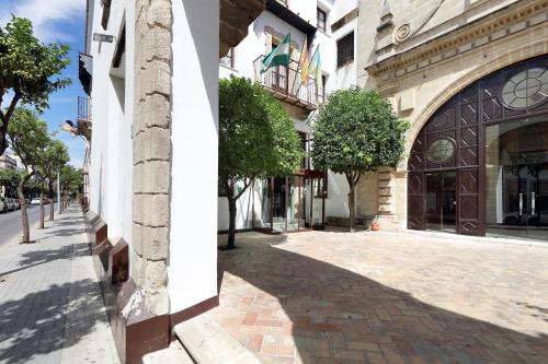 a building with a cobblestone street in front of a building at Crisol Monasterio de San Miguel in El Puerto de Santa María