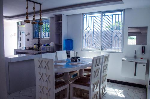 a kitchen with a table and chairs in a room at Daisy Apptment in Malindi