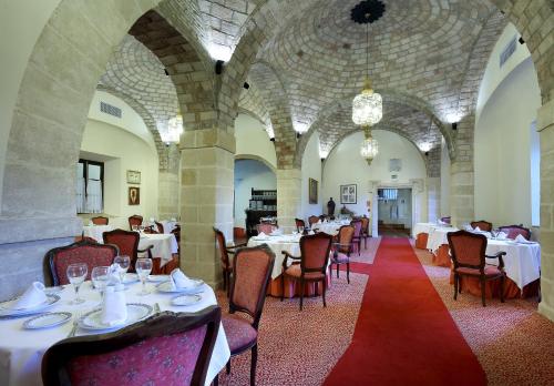 a dining room with tables and chairs in a building at Crisol Monasterio de San Miguel in El Puerto de Santa María