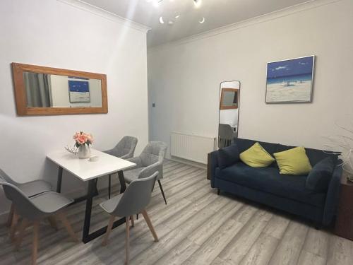 a living room with a couch and a table at 2B apartment near Glasgow SEC, OVO Hydro & city centre in Glasgow