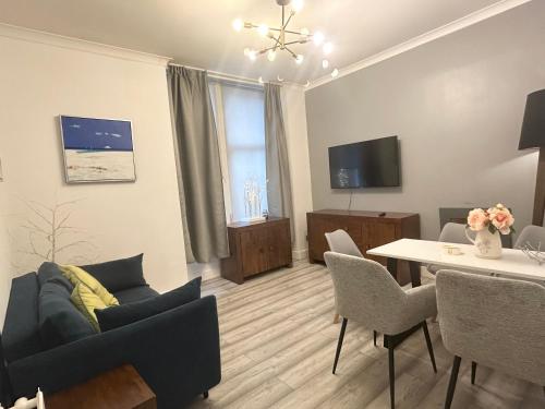 a living room with a couch and a table at 2B apartment near Glasgow SEC, OVO Hydro & city centre in Glasgow