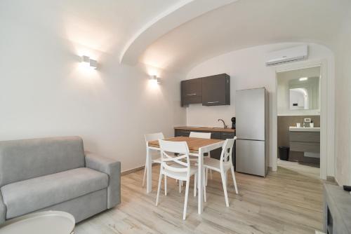 a kitchen and dining room with a table and a couch at AM8 - Cozy apartment in the center in Perugia