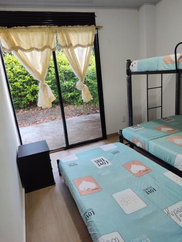 a room with two bunk beds and a window at Casa Vacacional - Portales del Sol 2 in Tocaima