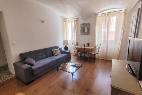 a living room with a couch and a table at Casa Rione in Omessa