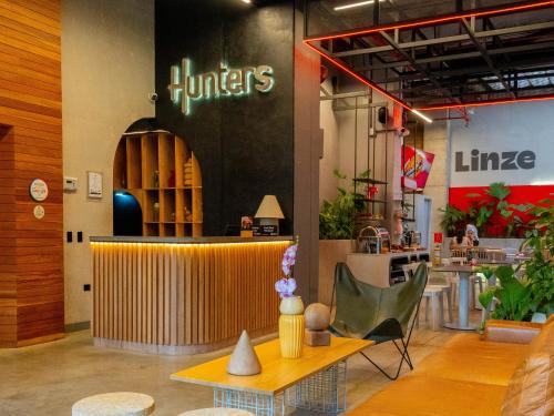 a restaurant with a table and chairs in a room at Hunters Hotel by Jalo in Medellín