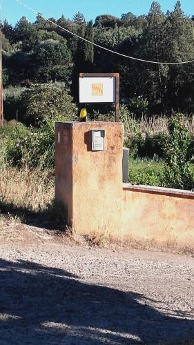 a sign sitting on the side of a road at B&B Salighes in Ozieri
