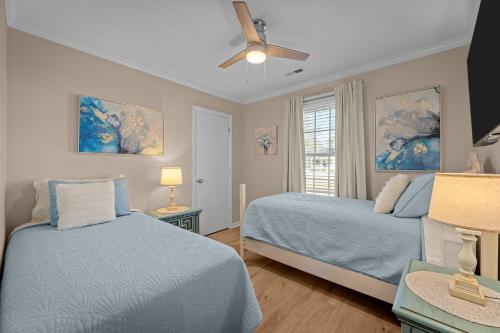 a bedroom with two beds and a ceiling fan at Pet-Friendly 3 BR Home with King Bed and Fenced Yard Near Downtown in New Bern
