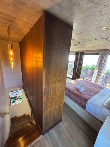 a bedroom with a bed and a large wooden wall at Victoria Ocean View Room in Ponta do Pargo