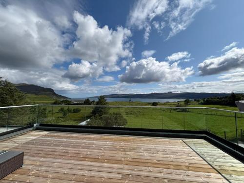 a view from the balcony of a house at Luxurious, Unique & Elegant Cottage with Hot Tub in Ollach