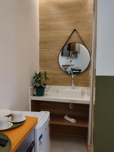a bathroom with a sink and a mirror on the wall at Studio 101 Cop 30 in Belém