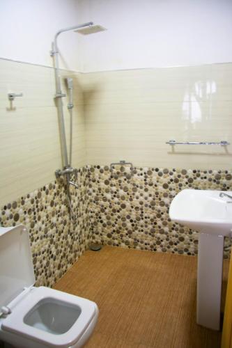 a bathroom with a toilet and a sink at Bliss In Viya in Ella