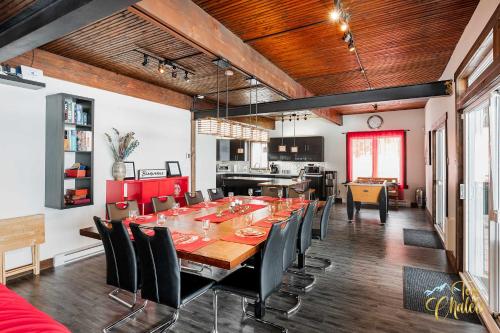 a dining room with a long table and chairs at Front LAKE Simon HOT TUB 6br 17p BEACH private in Lac-Simon