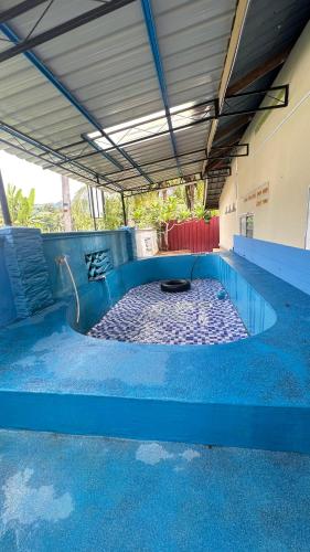 an empty swimming pool with a blue floor at D’sireh homestay in Sik