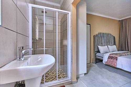 a bathroom with a sink and a glass shower at 45 on westmoreland in Johannesburg