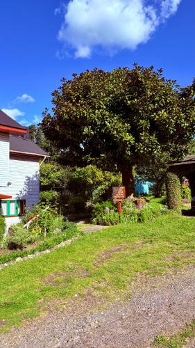 a yard with a sign in front of a house at Cabañas Casona Italiana in Lago Ranco