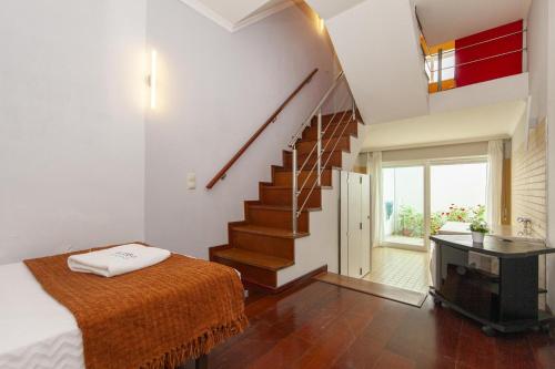 a bedroom with a staircase with a bed and a desk at B28 - Stylish Typical House in Lagos