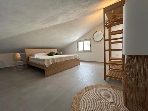 een slaapkamer met een bed en een houten ladder bij Villa Serenità - with private pool and ocean view in Ricadi