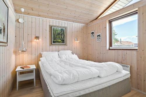 a large white bed in a room with a window at 30006-Malling-Laerkevaenget-8 in Malling
