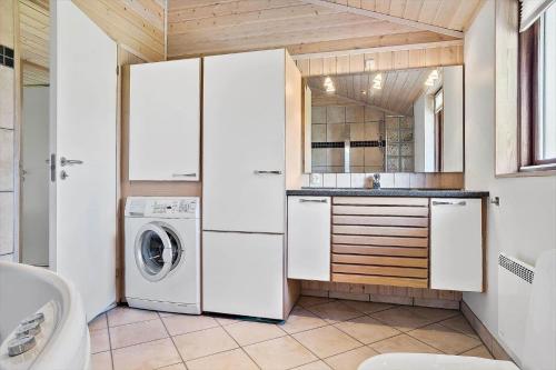 a kitchen with a washer and dryer in a room at 30006-Malling-Laerkevaenget-8 in Malling