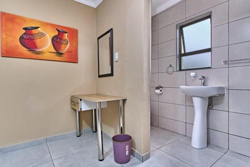 a bathroom with a sink and a toilet at 45 on westmoreland in Johannesburg