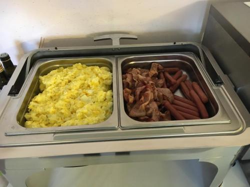 two trays of breakfast food in a refrigerator at Hotel Verdi in Vicenza