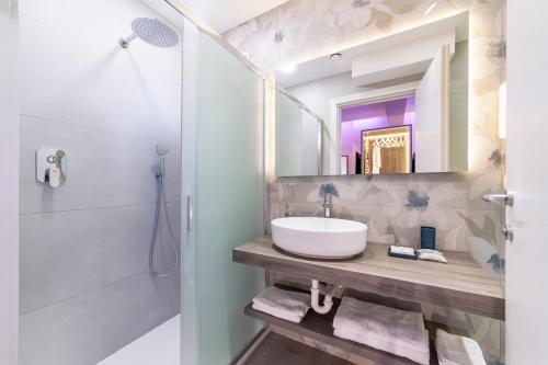 a bathroom with a sink and a shower at Hotel Gardenia in Rimini