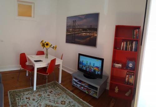 a living room with a table and a television at Stay Home Lisbon in Lisbon