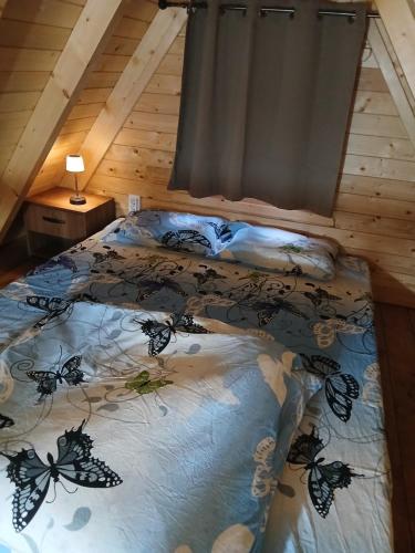 a bedroom with a bed with butterflies on it at Lake house angela in Kuside