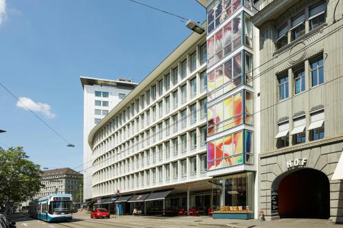 a bus is parked in front of a building at citizenM Zürich in Zürich