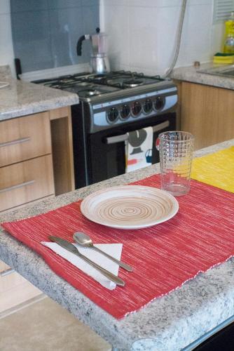 a kitchen counter with a plate and a knife and fork at Departamentos Arrayán in Puerto Montt