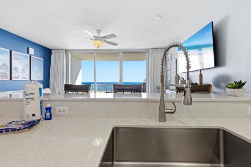 a kitchen sink with a view of the ocean at Beach Club unit 502C- Catalina in Gulf Highlands