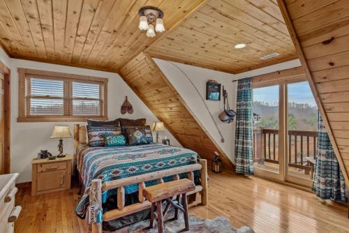 a bedroom with a bed and a wooden ceiling at Ponderosa 1887 in Vilas